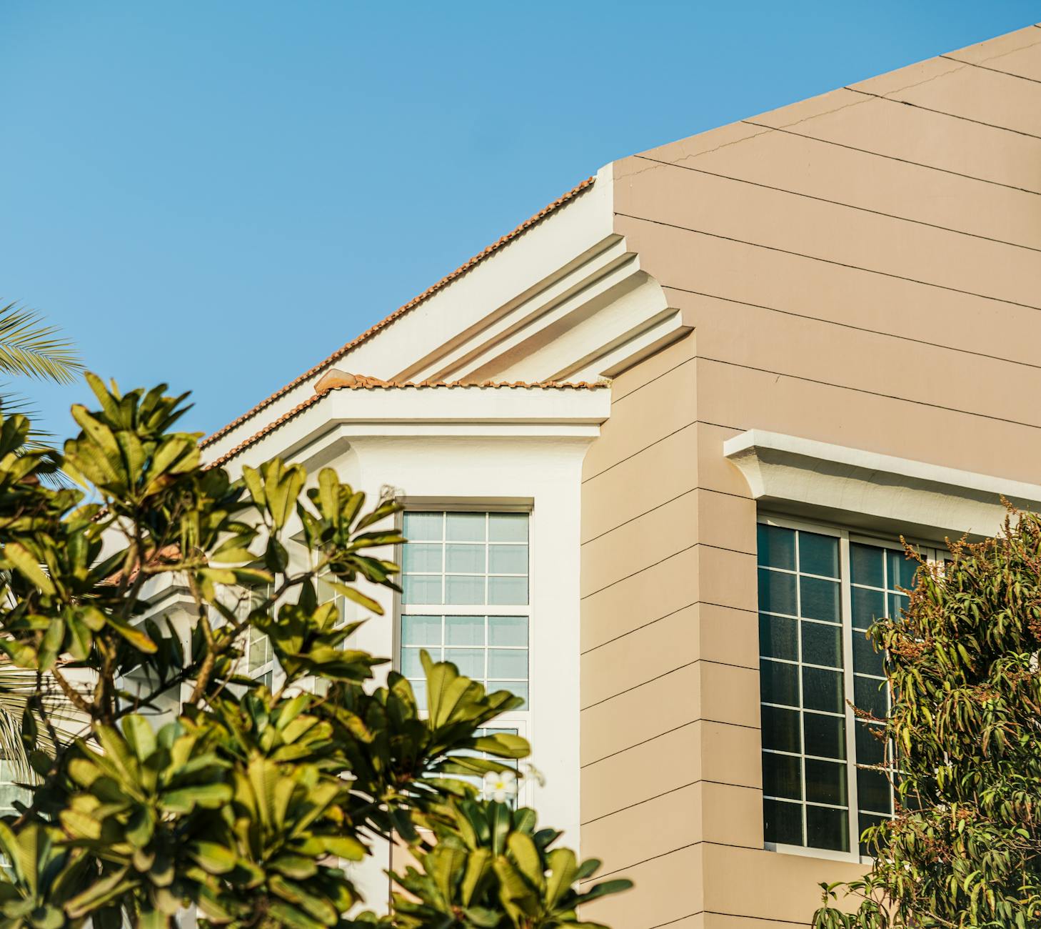 Beige residential building with green plants in Dubai