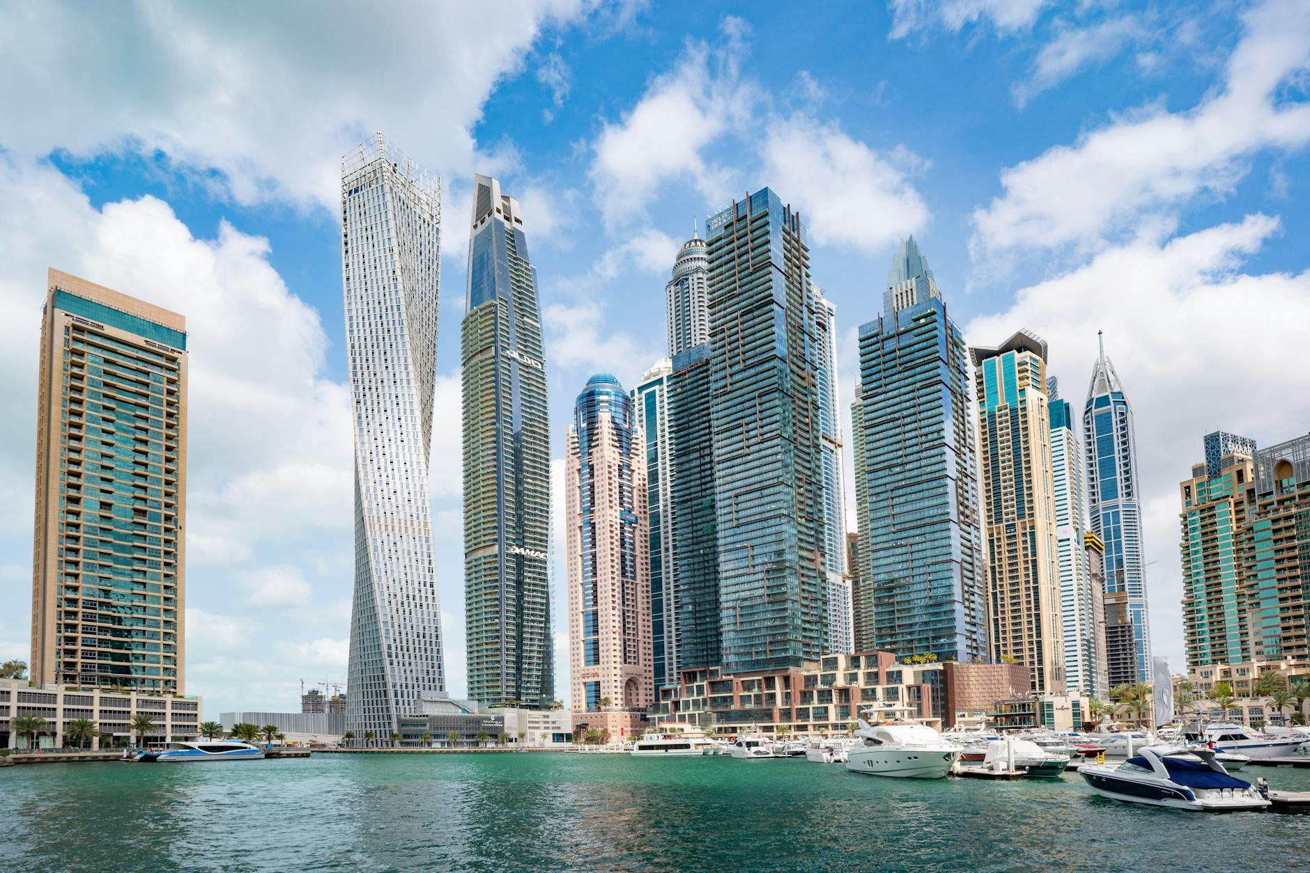 Dubai Marina with the Cayan twisted tower and waterfront yachts