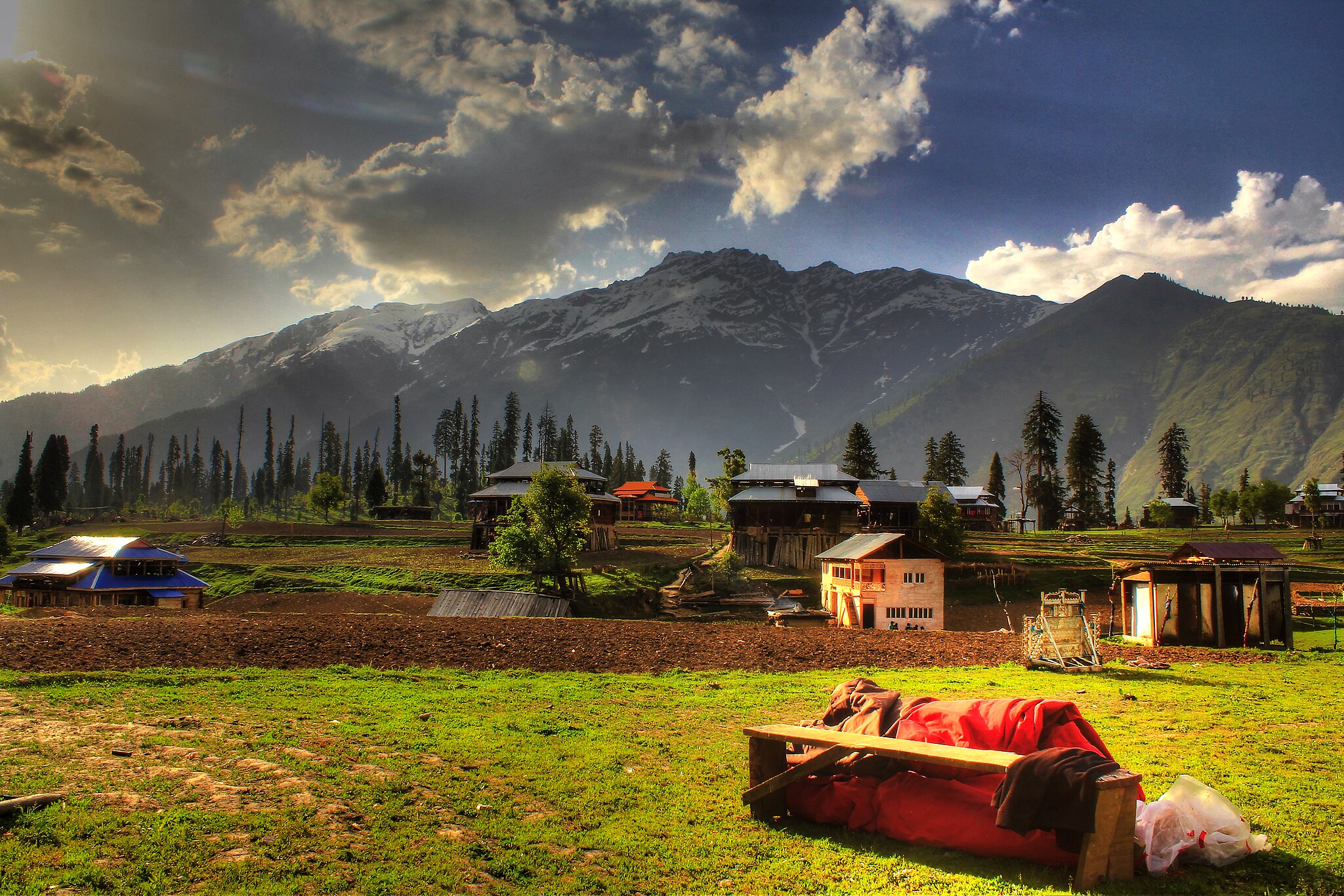 Mountain village in Kashmir with dramatic Himalayan backdrop